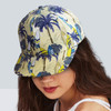 A flat peak cap featuring a tropical design with palm trees and surfboards, in shades of blue and yellow.