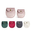 Oval velvet jewelry pouches in various colours: pink, green, burgundy, grey, and white, featuring a snap closure and branding.