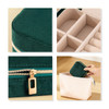 A green velvet jewellery organiser with a zip closure and compartments for storing items. Includes a light-coloured inner lining.