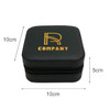 A black PU leather jewellery box with a zipper, featuring a logo on the top. Dimensions are 10cm x 10cm x 5cm.