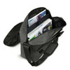 A grey satchel bag with an adjustable strap, featuring open compartments filled with magazines and documents.