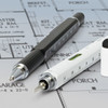 A multi-function pen set featuring a black pen with a silver tip and a white pen with a level and ruler, on a blueprint background.
