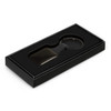A key ring in a square shape is presented in a black box with a cushioned interior.