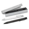 A collection of Lamy Safari pens in black, green, and white, displayed in a box with a soft interior.