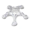A clear star-shaped massager with rounded tips. The product has a shiny finish and has a transparent appearance.