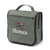 A green toiletry bag with a fold-over flap, featuring a logo on the front and side zippered pockets.
