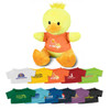 A yellow duck plush toy wearing an orange shirt, surrounded by various small shirts in different colours.