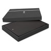 A black A5 portfolio with a zipper presented in a black box, featuring a logo on the portfolio.