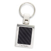 A silver key ring with a rectangular carbon fibre insert and a logo. The key ring features a polished finish.