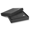 A black wallet in an open box with a logo, featuring a sleek design and textured exterior.