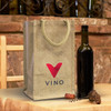 A jute wine carrier in natural colour with a red logo, alongside a dark wine bottle and cork on a rustic table.