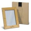 A wooden photo frame in a light brown bamboo finish, with a protective box featuring minimalistic design.