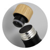 A drink bottle with a black body and a natural bamboo cap, showcasing its open top and stainless steel interior.