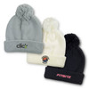 Three beanies in grey, white, and black, each with a pom-pom and featuring different logos.