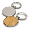 A round key ring featuring a silver metal frame with a wooden base on one side. It has a logo.