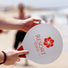 A paddle ball game featuring a large, white paddle with a red logo and a small ball, set against a beach background.