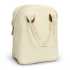A cream-coloured lunch bag with brown leather handles, featuring a zippered opening and a front pocket.