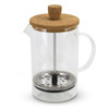 A glass coffee plunger with a cork lid, metal filter, and a black handle, designed for brewing coffee or tea.