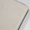 A textured beige cover of a portable drawing set with a black edge. Features a branding logo.