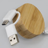 A bamboo retractable charging cable with white connectors, featuring a circular bamboo casing.