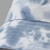 A blue and white tie dye bucket hat featuring stitched detailing and a logo.