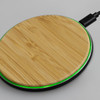 A bamboo wireless fast charger with a green LED ring, featuring a circular design and black base.