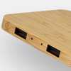 A bamboo wireless charging hub with a sleek design featuring multiple ports on one side.