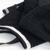 A black terry golf towel with ribbed texture, featuring white detailing and a loop for hanging.