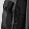 A grey and black Fjord Backpack features zippers and adjustable straps, with various textured materials.