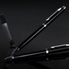 A black pen and pencil set with a sleek design, featuring metallic accents and a clear display case.
