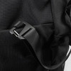 A close-up of a black duffle bag featuring a plastic buckle and strap, showcasing its durable fabric texture.