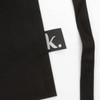 A black gardening apron with a small logo tag on the side.