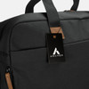 A black duffle bag with a leather tag and a logo, featuring sturdy handles and a sleek design.