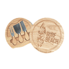 A wooden cheese board with three knives, featuring a Surf Beach logo and a natural finish.