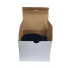 A coffee mug in a cardboard box, featuring a sleek black design and a handle. The box is open, showcasing the mug inside.