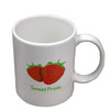 A white ceramic mug featuring a strawberry design and a logo, presented in a folded box.