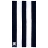 A cotton beach towel featuring a striped pattern in black and white, with a logo in the corner.
