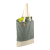 A grey and cream tote bag with a logo, filled with various items, including packaging and a drink bottle.
