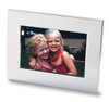 A nickel-plated photo frame featuring a vibrant image of two smiling girls with curly hair.