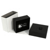 A black gift box containing plain silver cufflinks, presented alongside a white box.