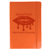 An orange journal with a textured cover and a logo, featuring an elastic band closure.