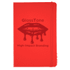 A red journal with a glossy finish and a logo on the front, featuring a design of lips and dripping effect.