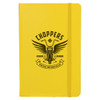 A yellow journal with a motorcycle graphic and an emblem featuring wings and text on the cover.