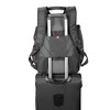 A black checkpoint-friendly backpack featuring multiple storage compartments and straps for easy transport on a trolley.