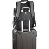 A grey backpack with multiple compartments sits atop a black suitcase, featuring a pull handle. It has visible branding.