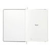 An open A5 hardcover notebook with a plain white interior and a logo on the first page. Features a black cover.
