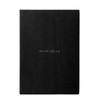 A black notebook featuring a logo on the front cover. It has a sleek and minimalist design.