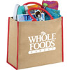 A large jute tote bag in natural with red handles, filled with books, a drink bottle, and other items.