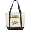 A large cream tote bag with black handles and bottom, featuring a logo on the front and a patterned pocket inside.