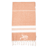A 100% cotton Turkish towel in a warm orange hue with white stripes and frayed edges, featuring a logo.